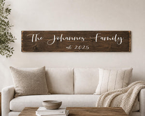 Large above sofa the wall wood sign sized 84" x 14.5" stained dark walnut. The johnson family established white lettering above cream sofa