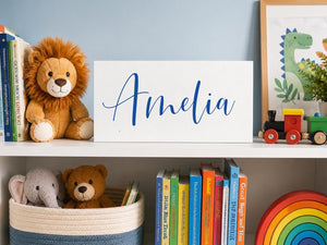 Kids Name Sign Bright cobalt blue with name Amelia on toy shelf in childs room