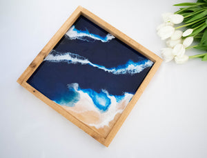wood serving tray ocean themed. blue and white hand painted on wood. on table with tulips